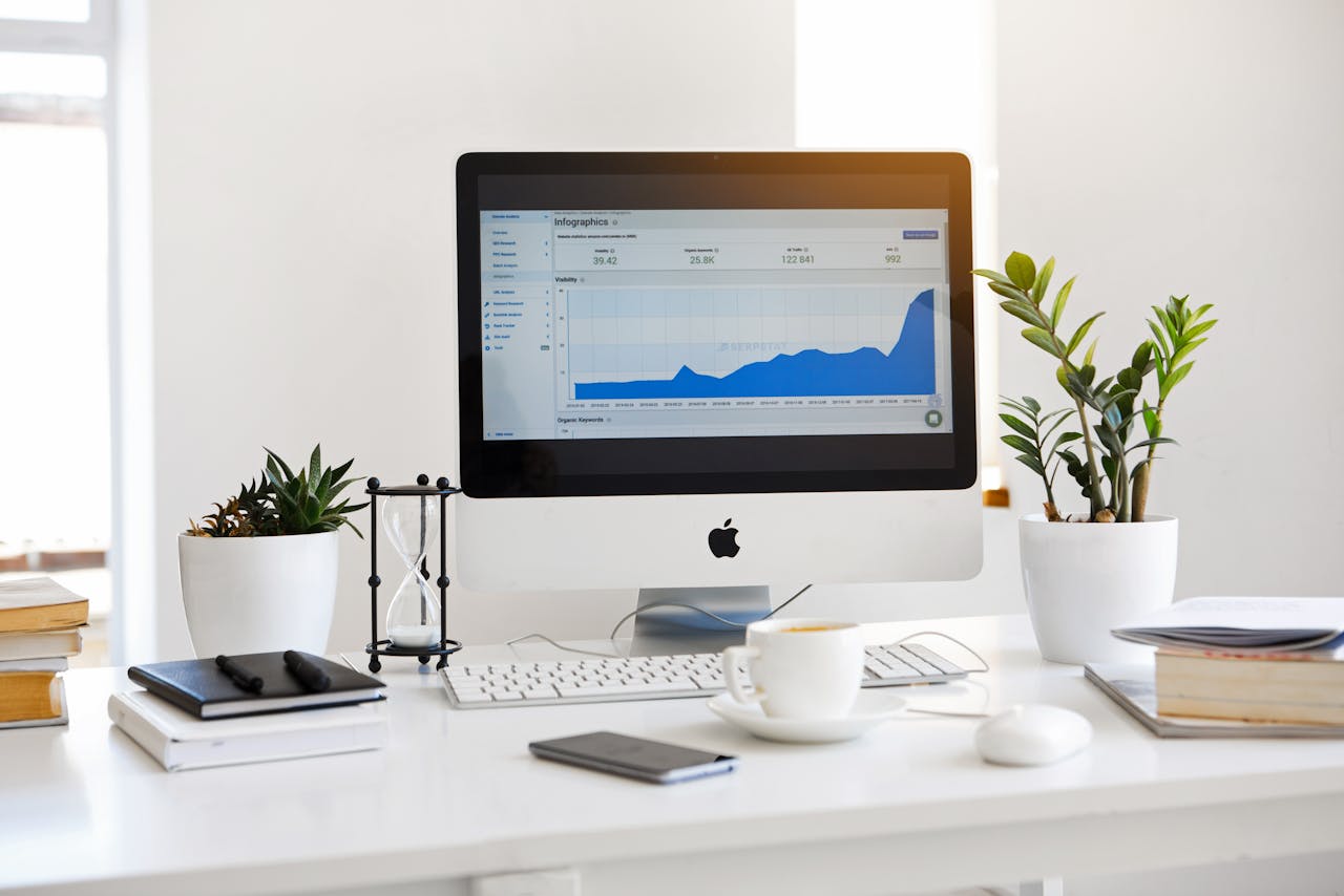 services-02 A clean, contemporary workspace featuring a desktop with analytics on the screen and plants for a fresh look.